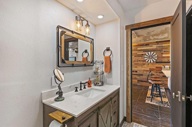 bathroom featuring marble finish floor and vanity