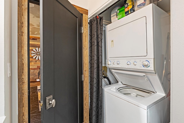 clothes washing area featuring laundry area and stacked washing maching and dryer