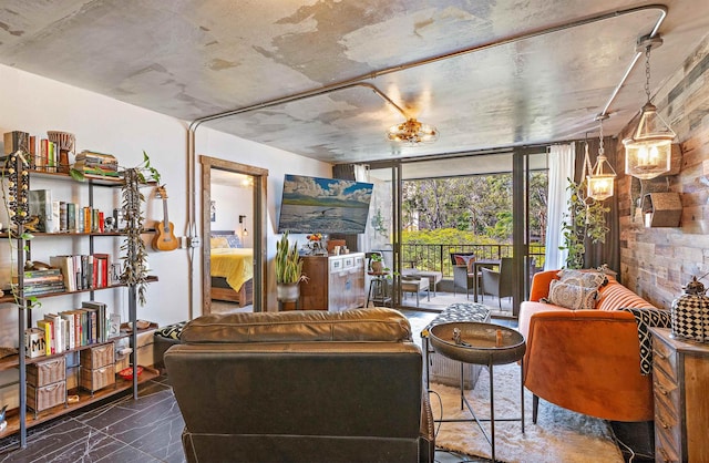 living area featuring marble finish floor and a wall of windows