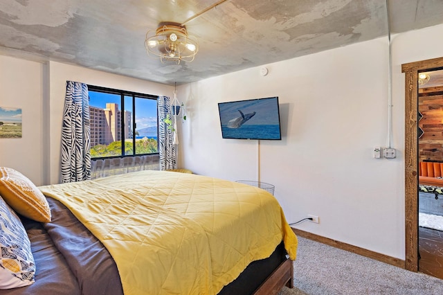 carpeted bedroom featuring access to exterior and baseboards