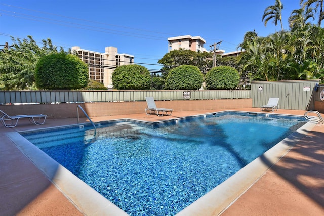 pool featuring a patio and fence