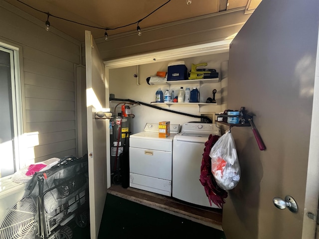 laundry area with washer and dryer and water heater