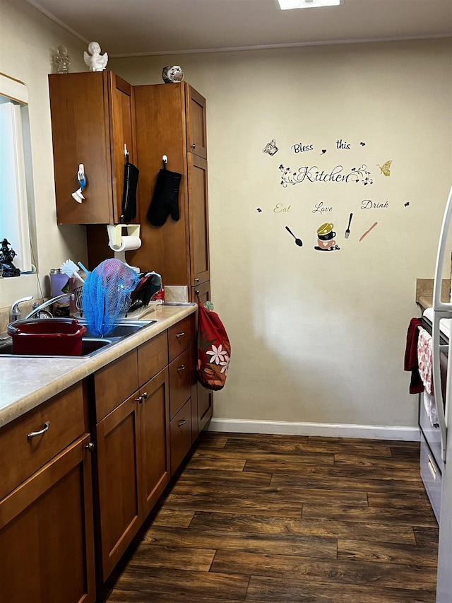 kitchen featuring sink and dark hardwood / wood-style floors