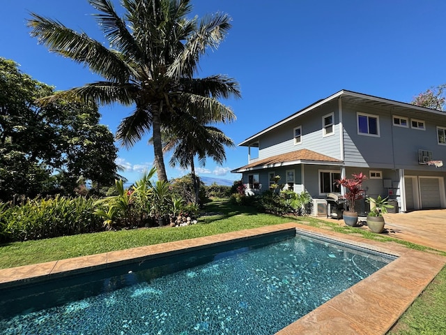 view of swimming pool with a lawn