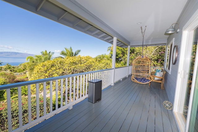 wooden terrace featuring a water view