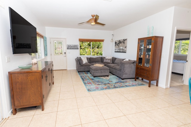 living room featuring ceiling fan, a wealth of natural light, and light tile floors