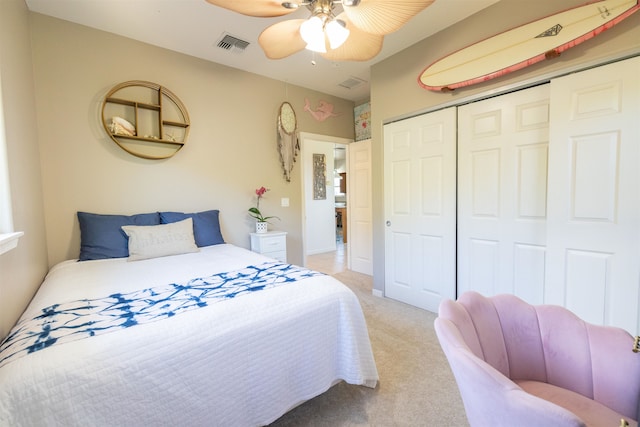 carpeted bedroom with a closet and ceiling fan