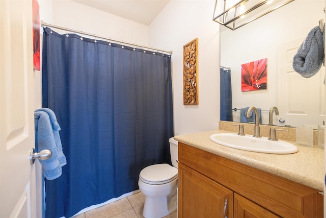 bathroom with tile floors, toilet, and vanity with extensive cabinet space