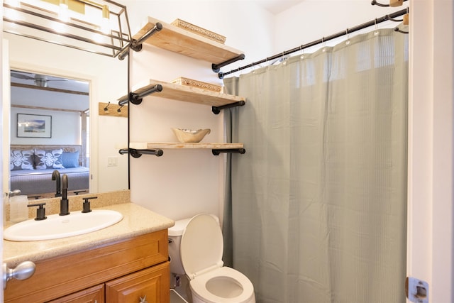 bathroom featuring toilet and vanity with extensive cabinet space