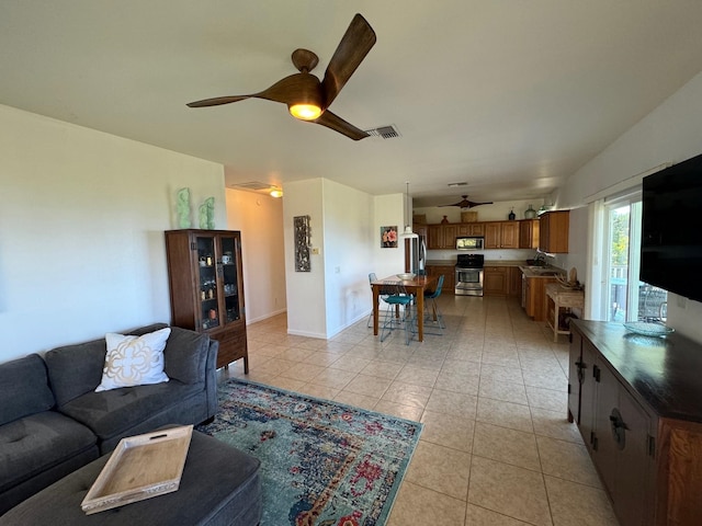 tiled living room featuring ceiling fan