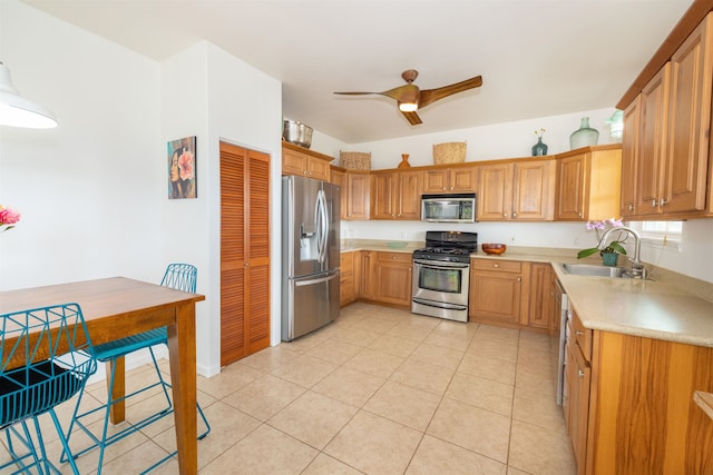 kitchen featuring appliances with stainless steel finishes, ceiling fan, light tile floors, and sink