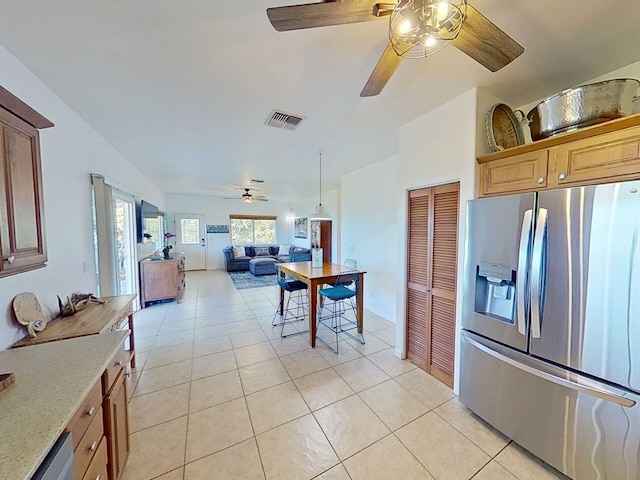 kitchen featuring ceiling fan, stainless steel appliances, and light tile flooring