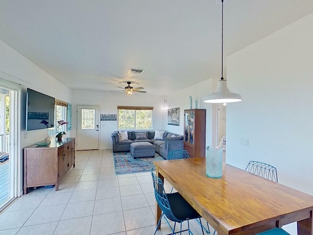 tiled dining room featuring ceiling fan and plenty of natural light