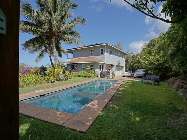 view of pool with a yard