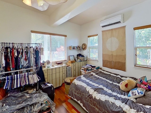 bedroom with ceiling fan, a wall mounted AC, and dark hardwood / wood-style floors