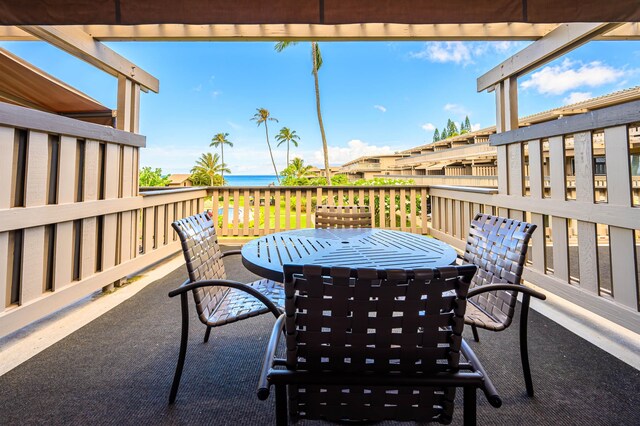 view of patio featuring a deck with water view