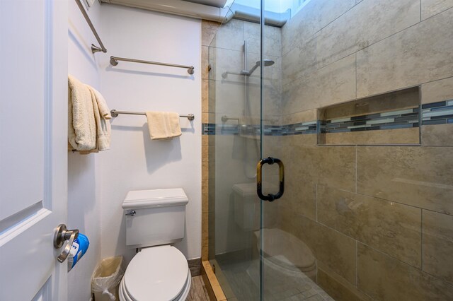 bathroom featuring toilet and walk in shower