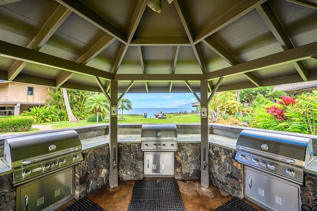 view of patio featuring an outdoor kitchen and a gazebo