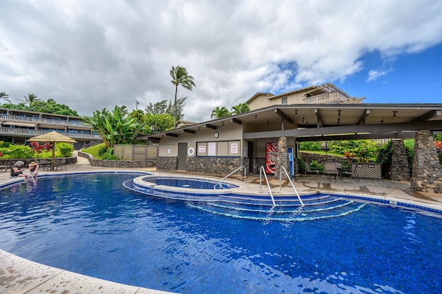 view of pool featuring a patio and a hot tub