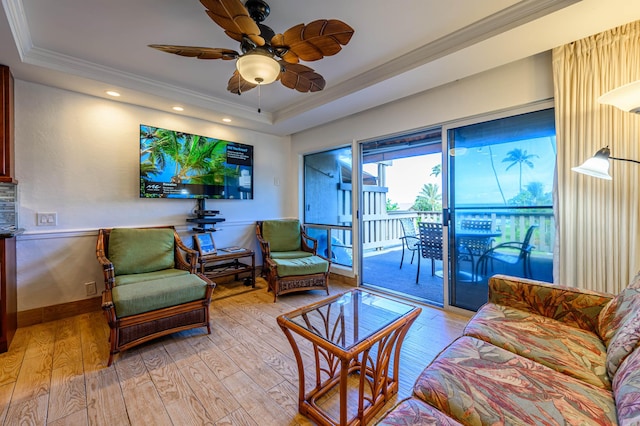 living room featuring light hardwood / wood-style floors, ceiling fan, and ornamental molding