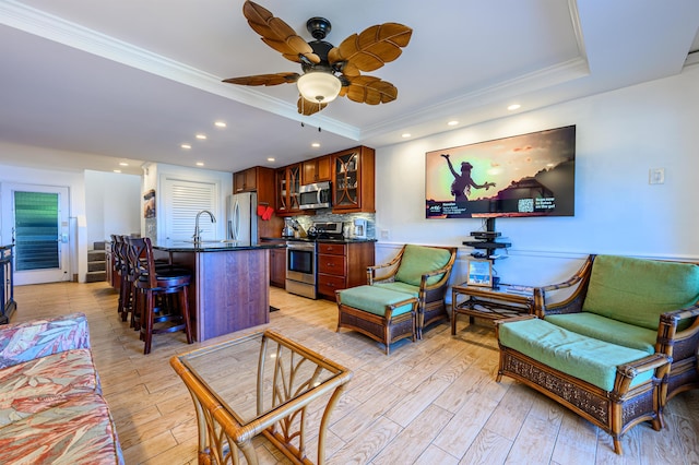 living room featuring crown molding, a raised ceiling, and a wall mounted air conditioner