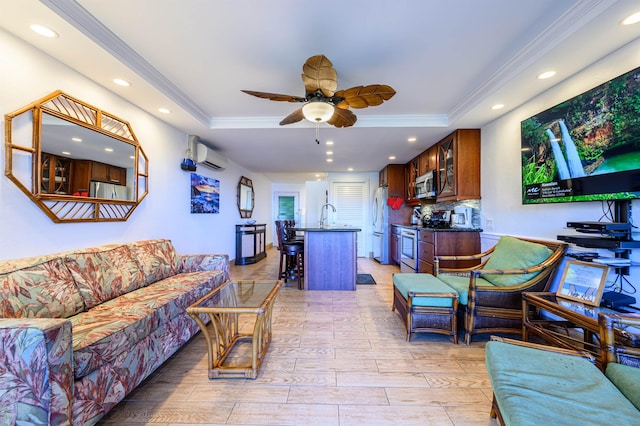 living room featuring a wall mounted air conditioner, ornamental molding, and a tray ceiling