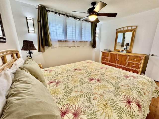 bedroom featuring wood finished floors and ceiling fan