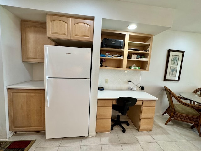 home office with built in desk and light tile patterned floors
