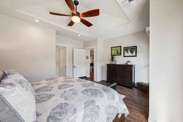 bedroom featuring visible vents, a ceiling fan, dark wood-style floors, recessed lighting, and a raised ceiling