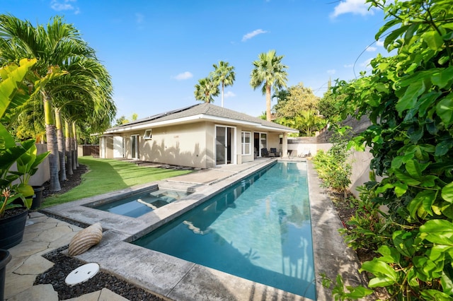 view of swimming pool featuring a patio, a fenced in pool, an in ground hot tub, a fenced backyard, and a lawn