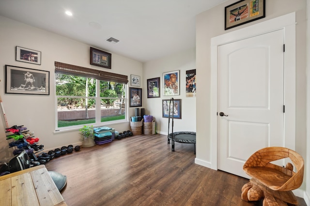 misc room with visible vents, baseboards, and dark wood-type flooring