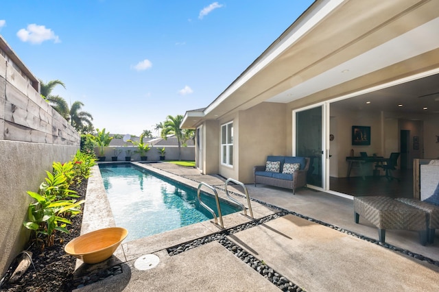 view of swimming pool featuring a patio area, a fenced in pool, and a fenced backyard