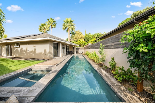 view of swimming pool featuring an in ground hot tub, a fenced backyard, a fenced in pool, and a lawn