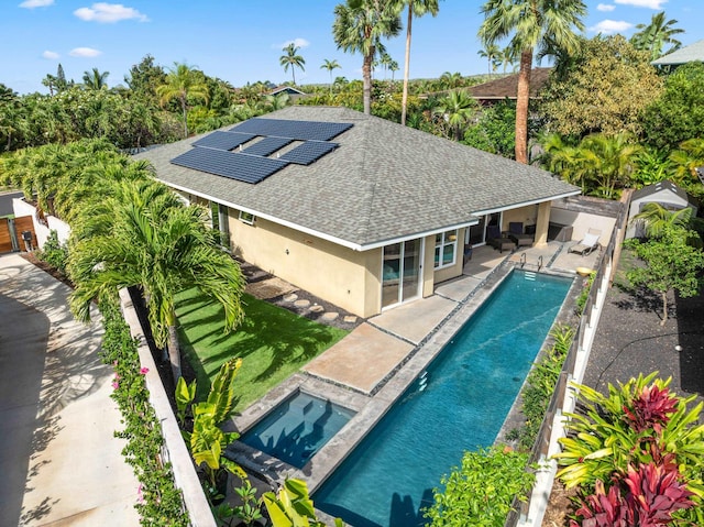 outdoor pool featuring a patio area, an in ground hot tub, and a fenced backyard