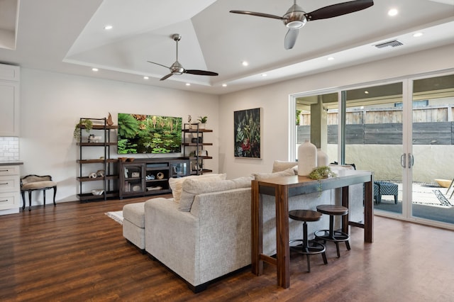 living area with recessed lighting, visible vents, ceiling fan, and dark wood finished floors