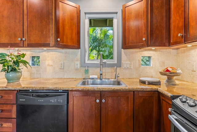 kitchen with light stone countertops, backsplash, sink, stainless steel range oven, and black dishwasher