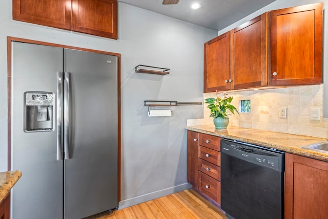 kitchen with dishwasher, stainless steel refrigerator with ice dispenser, light hardwood / wood-style floors, and light stone counters