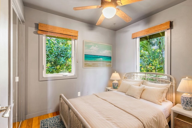 bedroom with ceiling fan, a closet, and hardwood / wood-style flooring