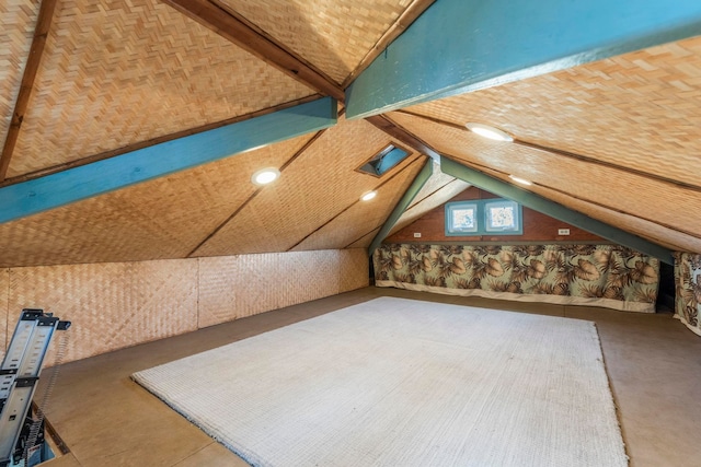 additional living space featuring lofted ceiling