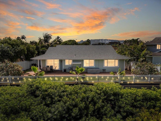 view of front of property with a patio area and a fenced backyard