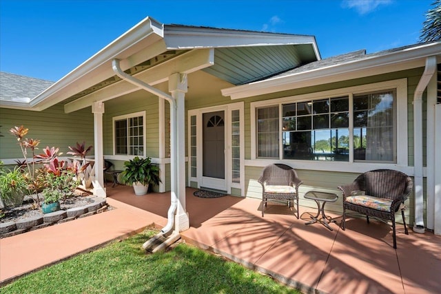 back of property featuring roof with shingles and covered porch