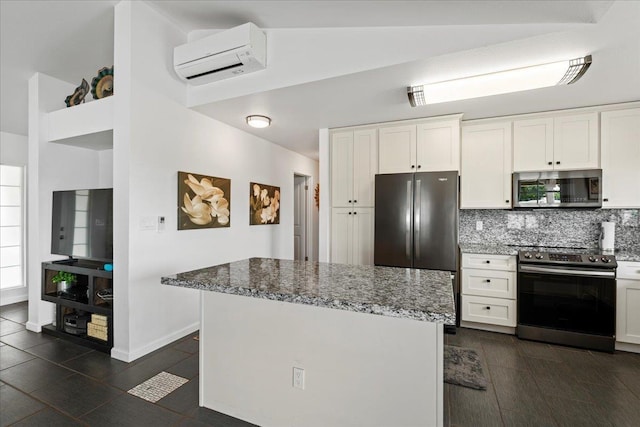 kitchen with backsplash, white cabinets, a wall unit AC, and stainless steel appliances