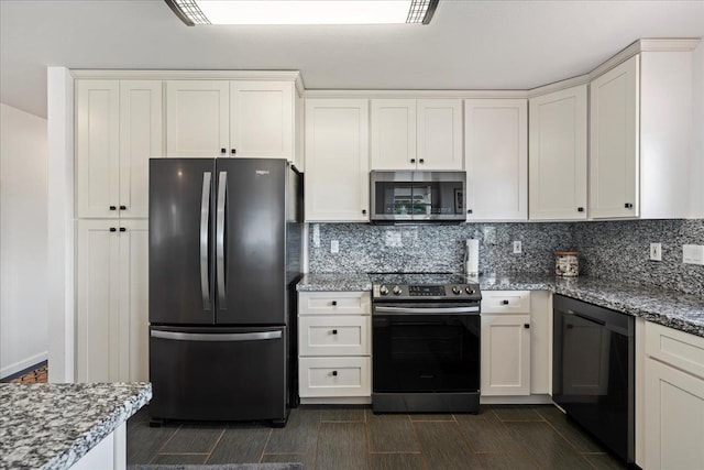kitchen with appliances with stainless steel finishes, light stone counters, and backsplash