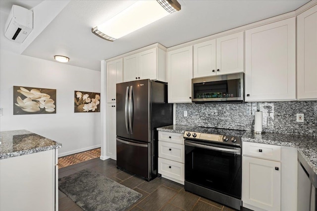 kitchen with light stone countertops, tasteful backsplash, white cabinetry, wood tiled floor, and stainless steel appliances