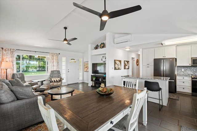 dining area with vaulted ceiling, an AC wall unit, and a ceiling fan