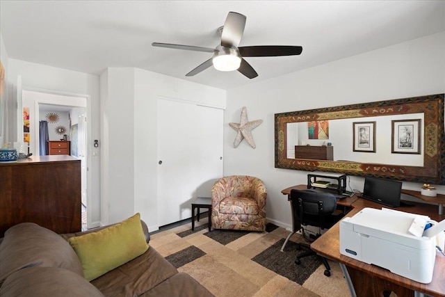 office space featuring carpet flooring, baseboards, and a ceiling fan