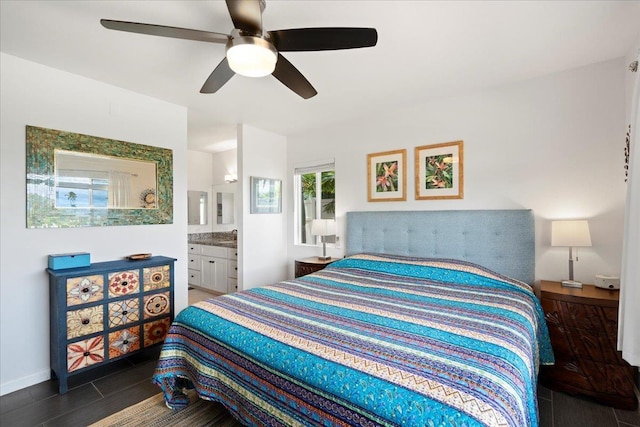 bedroom with wood finished floors, ensuite bathroom, and a ceiling fan