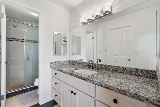 full bathroom with a shower stall, vanity, and toilet