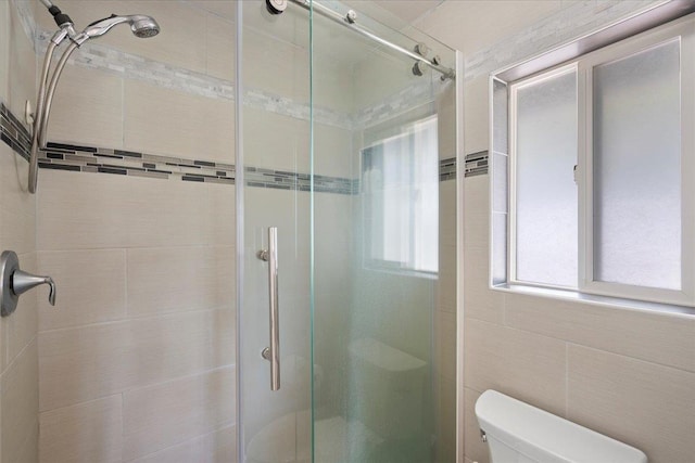 full bath featuring toilet and a stall shower