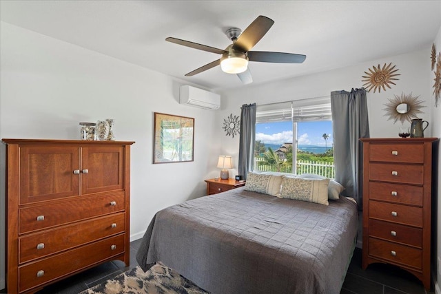 bedroom with ceiling fan and a wall unit AC